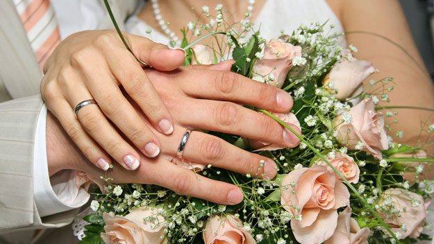 Wedding rings on married couple