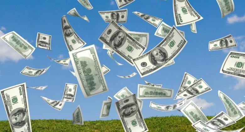 money falling in the sky and green grass background