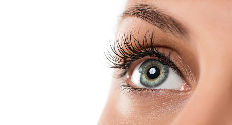 Close up of natural female eye isolated on white background