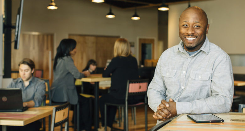 Portrait of happy restaurant manager in cafe, St. Louis, MO, Int