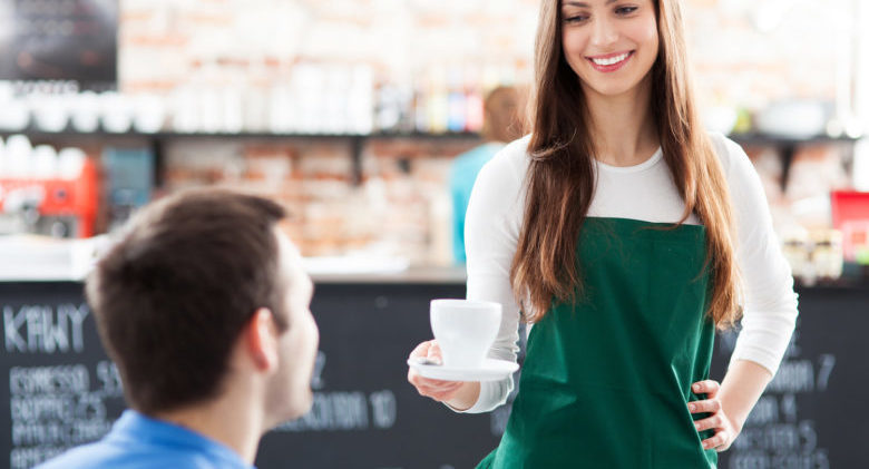 Waitress serving man coffee