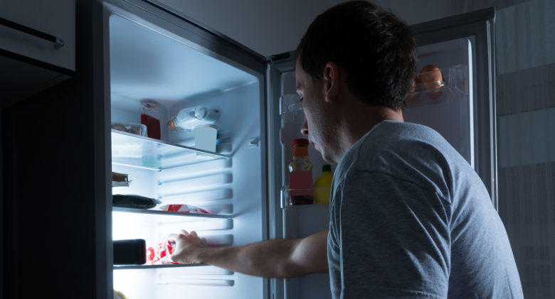 Portrait Of A Man Taking Food From Refrigerator