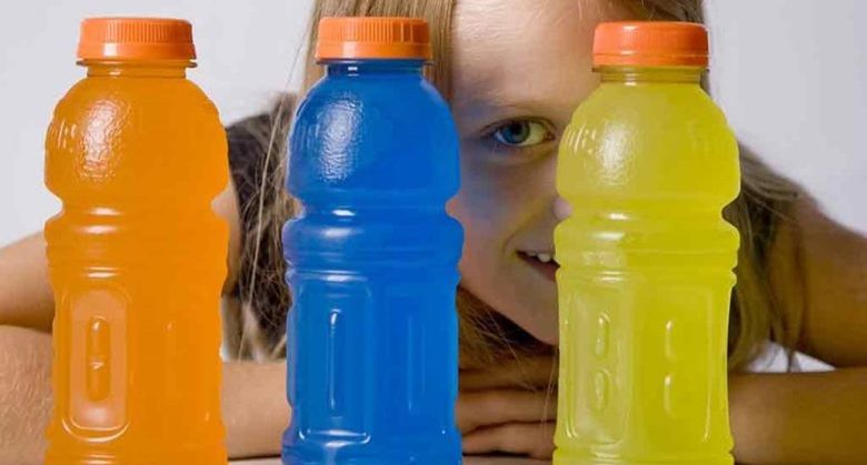 Girl looking through bottles of sports drink